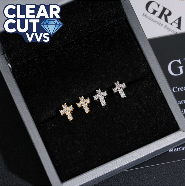 Gold cross-shaped earrings on a black cushion with 'Clear Cut VVS' branding.