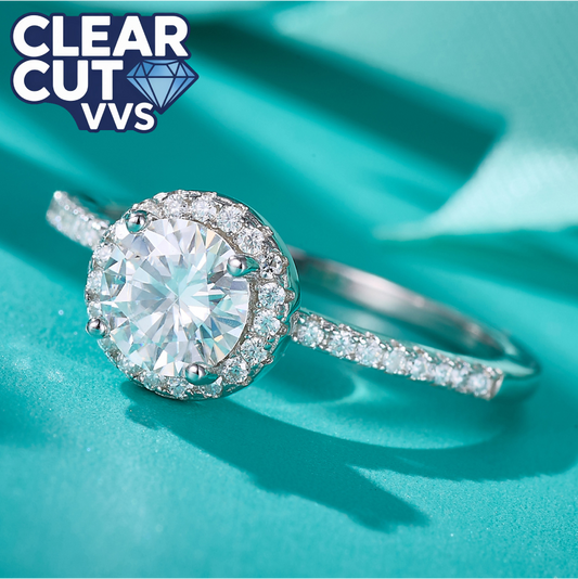 Diamond ring with 'Clear Cut VVS' label on a teal background