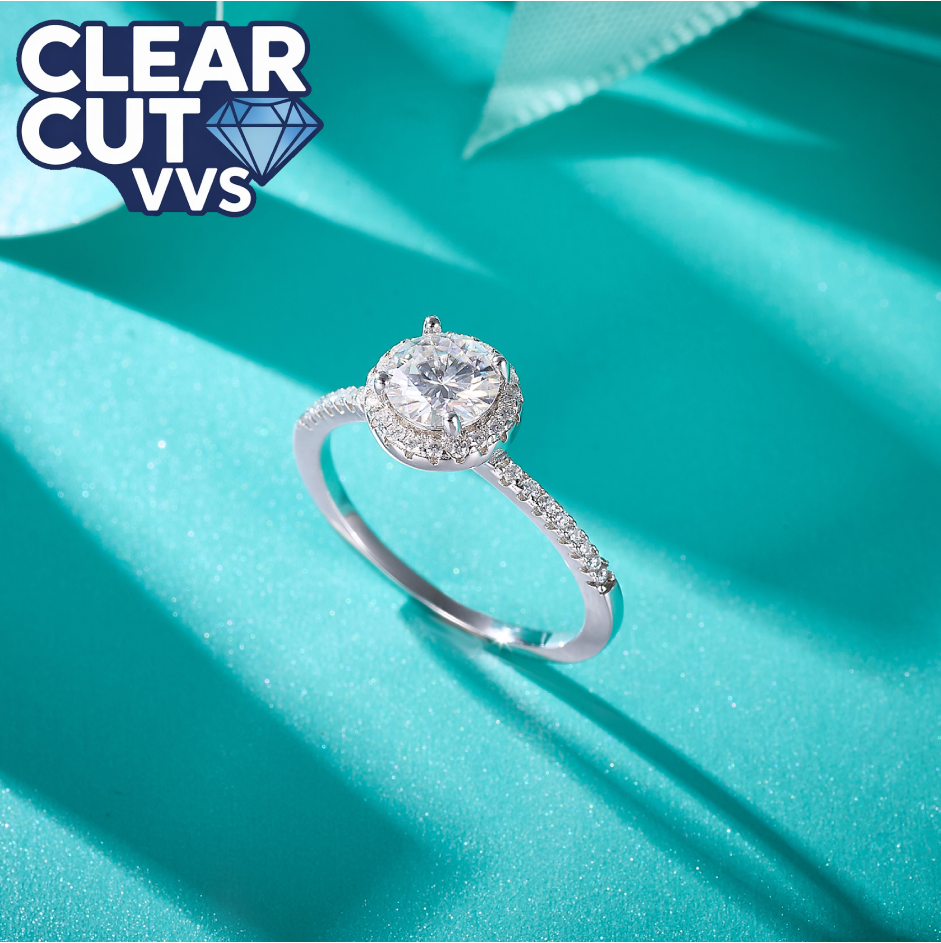 Diamond ring on a turquoise fabric background with 'Clear Cut VVS' branding.